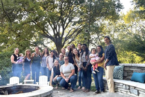 Several faculty members at bonfire / bbq