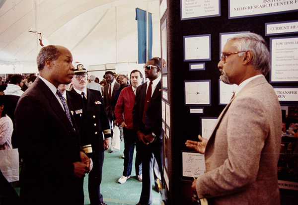 Dr. Bhattacharya describing the 'Quantitative Posturagraphy' technology to Dr. Louis Wade Sullivan