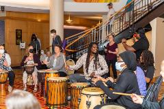 group of people performing a drum circle