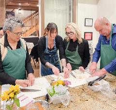 Group of people cooking a healthy meal at the turner farm teaching kitchen