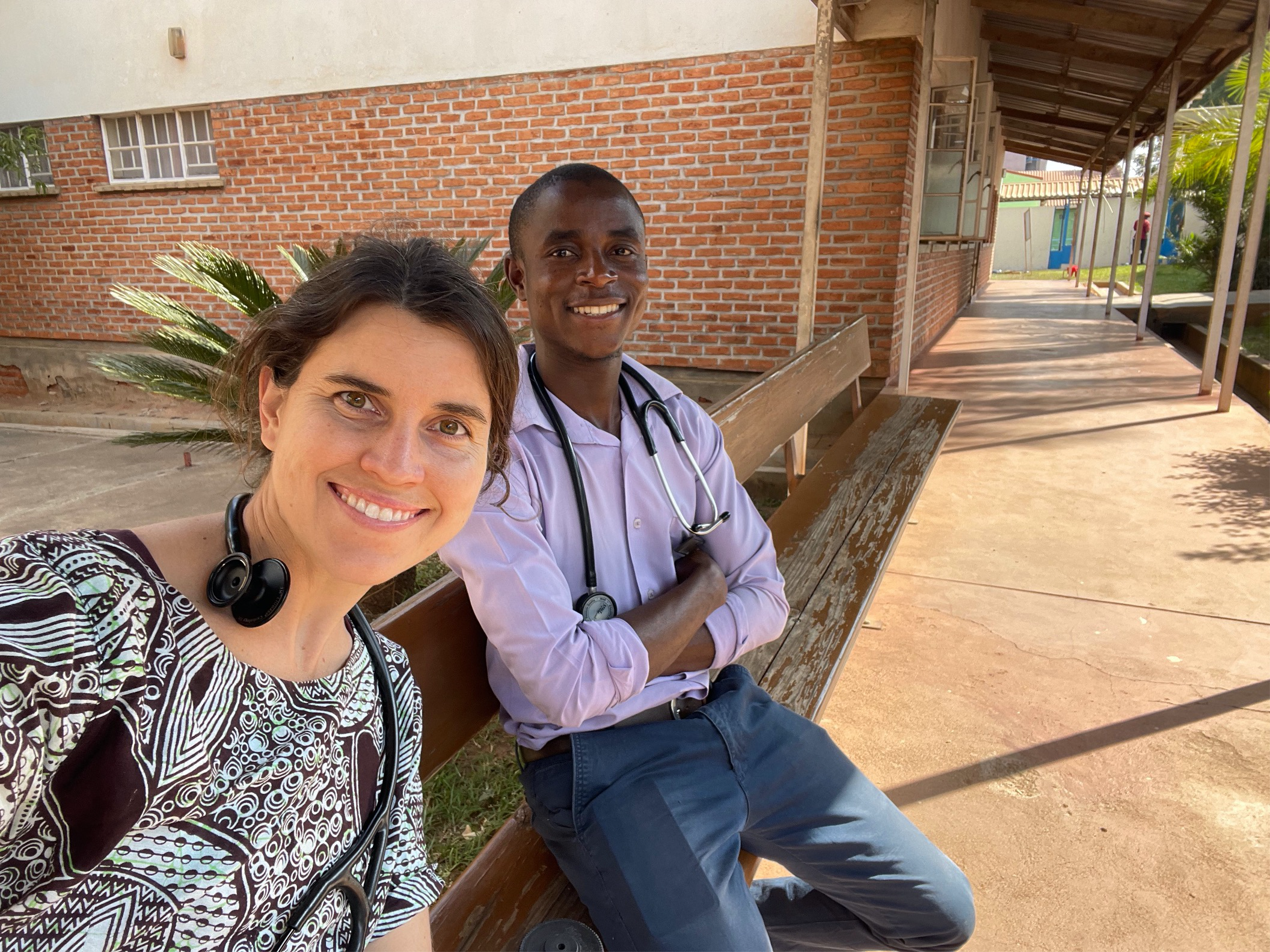 Image of two doctors on a bench